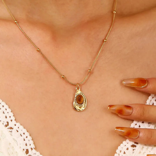 Goudkleurige bolletjes ketting met bruin steentje Sweet 7