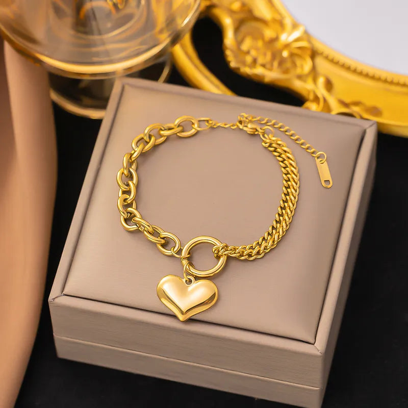 Armband goudkleurig met twee verschillende schakels en hart