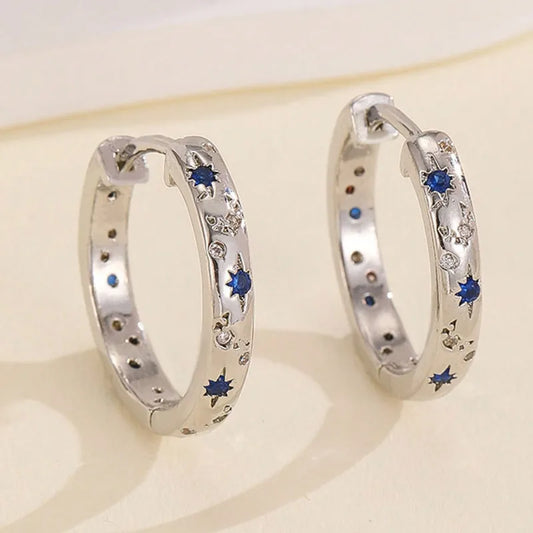 Zilverkleurige oorringen met blauwe zirconia